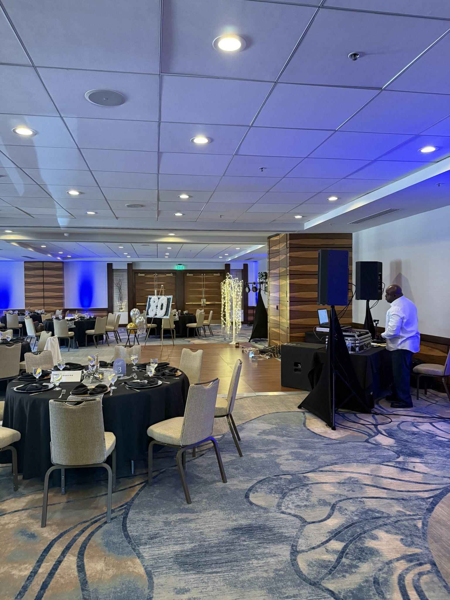 360 photo booth setup in hotel ballroom with blue uplighting, corporate event Tucson