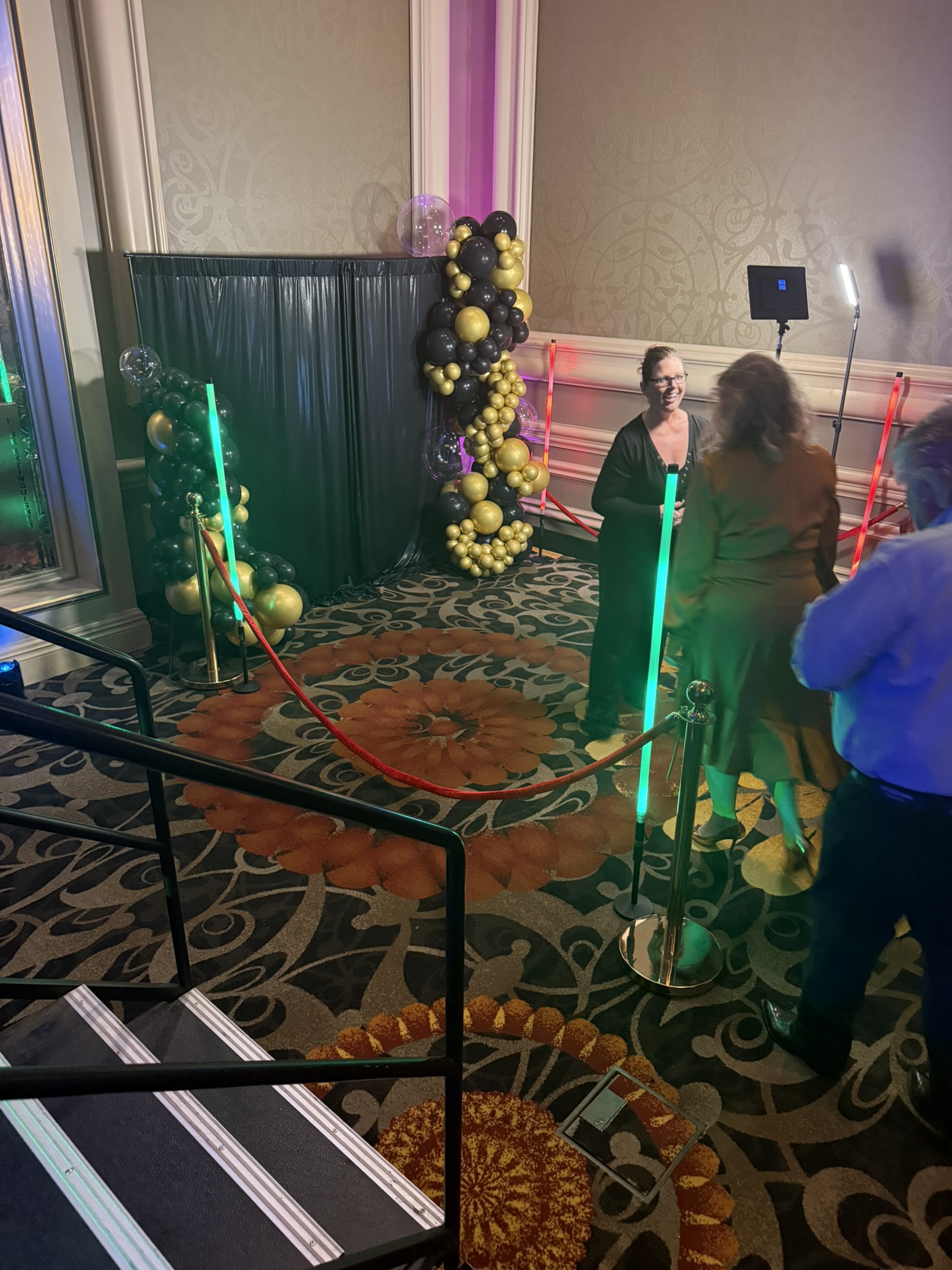 Photo booth with gold balloon arch at Tucson hotel ballroom wedding
