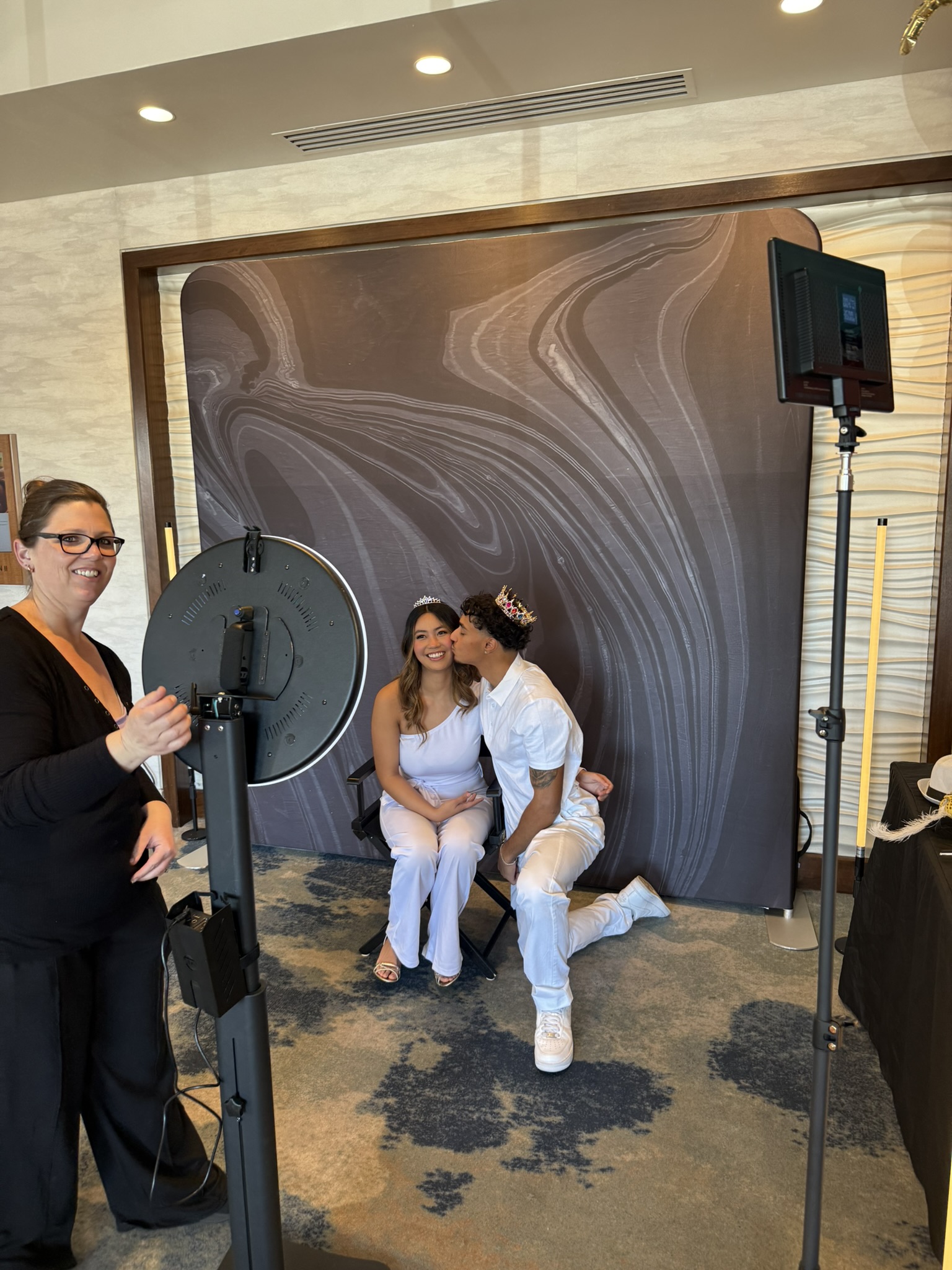 Studio Photo Experience — couple posing at photo booth with marble backdrop